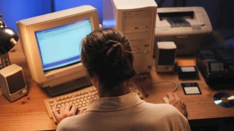 Person using a vintage beige CRT computer with floppy disks and CD-ROM — representing the Web 1.0 era of static information access